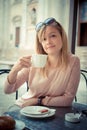 Beautiful blonde woman having breakfast at the bar Royalty Free Stock Photo