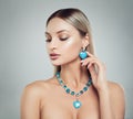 Beautiful Blonde Woman in Jewelry Necklace and Earrings with Diamonds and Turquoise Gem, Fashion Beauty Portrait. Makeup and Royalty Free Stock Photo