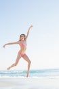 Beautiful blonde woman jumping on the beach Royalty Free Stock Photo