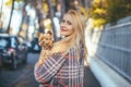 Beautiful blonde woman with a little dog in her arms Royalty Free Stock Photo
