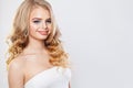 Beautiful blonde woman with long healthy curly hair and clear skin. Fashion girl smiling Royalty Free Stock Photo