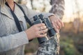 Young woman holding binoculars at sunset Royalty Free Stock Photo