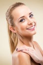 Beautiful blonde woman looking camera - light background Royalty Free Stock Photo