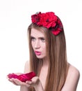 Beautiful blonde woman looking rose petals in her hands Royalty Free Stock Photo