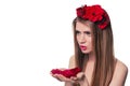 Beautiful blonde woman looking rose petals in her hands Royalty Free Stock Photo