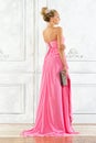 Beautiful blonde woman in a pink long dress. Royalty Free Stock Photo