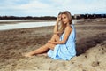 Beautiful blonde woman posing on an empty sea beach Royalty Free Stock Photo