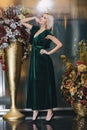 Beautiful Blonde woman posing in green dress