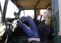 Beautiful blonde woman relaxing with her feet on the dashboard of a vintage safari vehicle Royalty Free Stock Photo