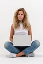 Beautiful blonde woman sitting on floor with laptop Royalty Free Stock Photo