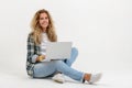 Beautiful blonde woman sitting on floor with laptop Royalty Free Stock Photo