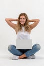 Beautiful blonde woman sitting on floor with laptop Royalty Free Stock Photo