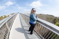 Beautiful blonde woman stands on the elevated boardwalk in Assateague Island Royalty Free Stock Photo
