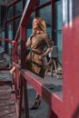 Beautiful Blonde Woman In Stylish Dress At Construction Site Near Construction Cradle. Attractive Worker, Developer Royalty Free Stock Photo