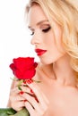 Beautiful blonde woman with stylish makeup holding red rose Royalty Free Stock Photo