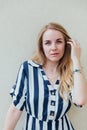 Beautiful blonde woman in summer striped dress