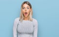 Beautiful blonde woman wearing casual clothes afraid and shocked with surprise and amazed expression, fear and excited face Royalty Free Stock Photo