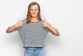 Beautiful blonde woman wearing casual clothes success sign doing positive gesture with hand, thumbs up smiling and happy Royalty Free Stock Photo