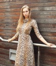 Beautiful blonde woman wearing a leopard dress and sunglasses Royalty Free Stock Photo