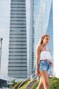 Beautiful blonde woman wearing short jeans walking on the street Royalty Free Stock Photo