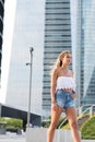 Beautiful blonde woman wearing short jeans walking on the street Royalty Free Stock Photo