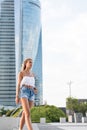 Beautiful blonde woman wearing short jeans walking on the street Royalty Free Stock Photo