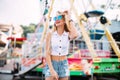 Beautiful blonde woman wearing sunglasses close-up portrait of a young girl hipster in the park attraction Street fashion con