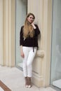 Beautiful blonde woman in white pants and corduroy jacket