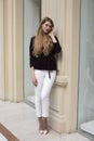 Beautiful blonde woman in white pants and corduroy jacket
