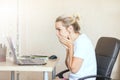 Beautiful blonde woman working on a laptop at home She is confused looking at the screen. Freelance, work at home concept Copy spa Royalty Free Stock Photo