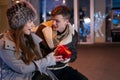 Beautiful blonde young adult surprises his girlfriend for Valentines day Royalty Free Stock Photo