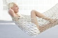 Beautiful blonde young girl relaxed on hammock