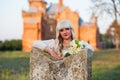 Blonde girl in a white dress on nature near architectural monuments in the open air