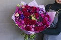 Beautiful blonde young woman holding in her hands big bouquet Royalty Free Stock Photo