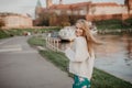 Beautiful blonde young woman walking beside the river at sunset have fun smile and play on camera Royalty Free Stock Photo