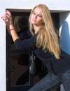 Beautiful blondy standing against windows