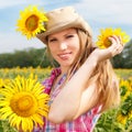 Beautiful Blondy Woman in Cowboy Hat with Sunflowers. Royalty Free Stock Photo