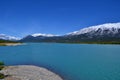 Beautiful blue Abraham Lake with high mountains covered with snow in the background. Royalty Free Stock Photo