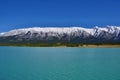 Beautiful blue Abraham Lake with high mountains covered with snow in the background. Royalty Free Stock Photo