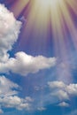 Beautiful blue bright sky, white cumulus clouds and sun rays Royalty Free Stock Photo