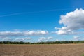 Beautiful blue cloud sky over mowed field.