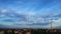 Beautiful blue clouds like a swirl over housing in Denpasar Bali