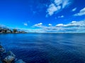 Beautiful blue and cloudy sky over a calm ocean. Royalty Free Stock Photo