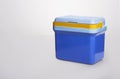 Beautiful blue cooler with a. yelllow handle on