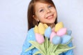 Beautiful blue-eyed girl stands with flowers in her hands