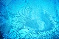 Beautiful blue frost patterns on frozen window as a symbol of Christmas wonder. Christmas or New year background