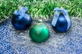 Blue and green Christmas balls on a silver tinsel Royalty Free Stock Photo