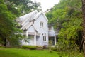 Beautiful blue house green grass and big tree Royalty Free Stock Photo