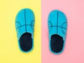 Beautiful blue house Slippers on pink and yellow background. The view from the top. Flat lay. Royalty Free Stock Photo