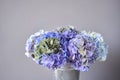 Beautiful blue hydrangea flowers in a vase on a table . Bouquet of light pink flower. Decoration of home. Wallpaper and Royalty Free Stock Photo
